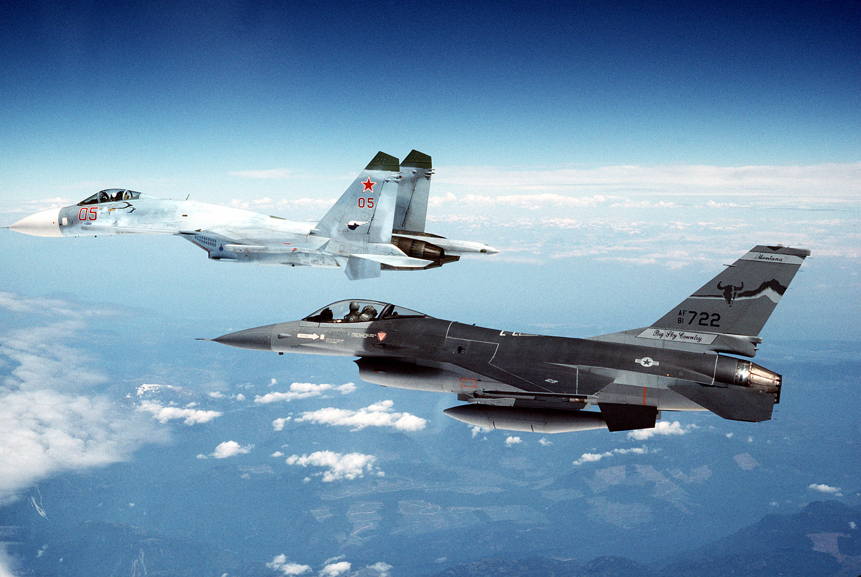 A Su-27 escorted by an F-16