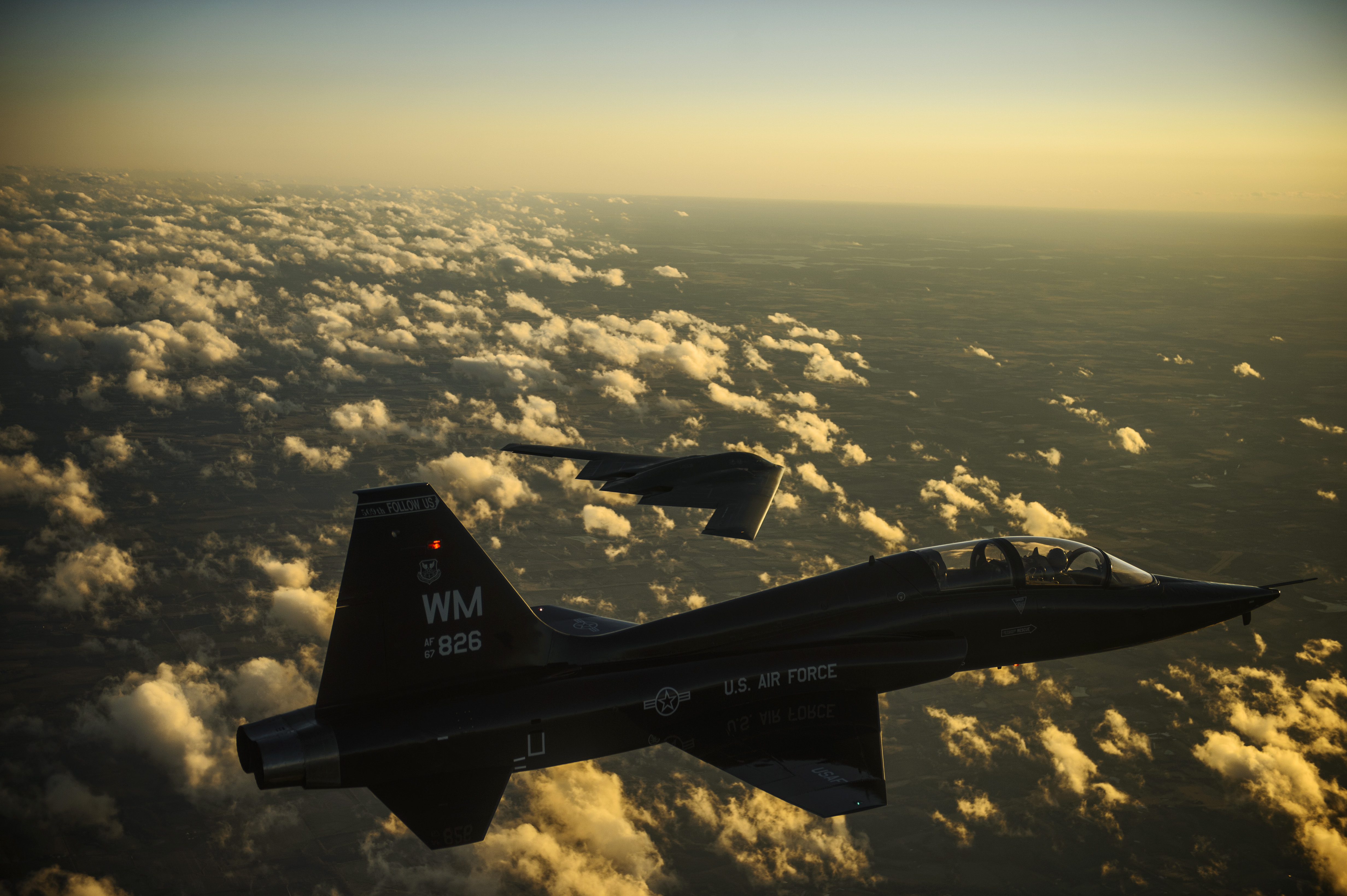 A U S. Air Force T-38 Talon aircraft and B-2 Spirit aircraft fly in formation during a training mission over Whiteman Air Force Base, Mo., Feb. 20, 2014 140220 F-RH756 606