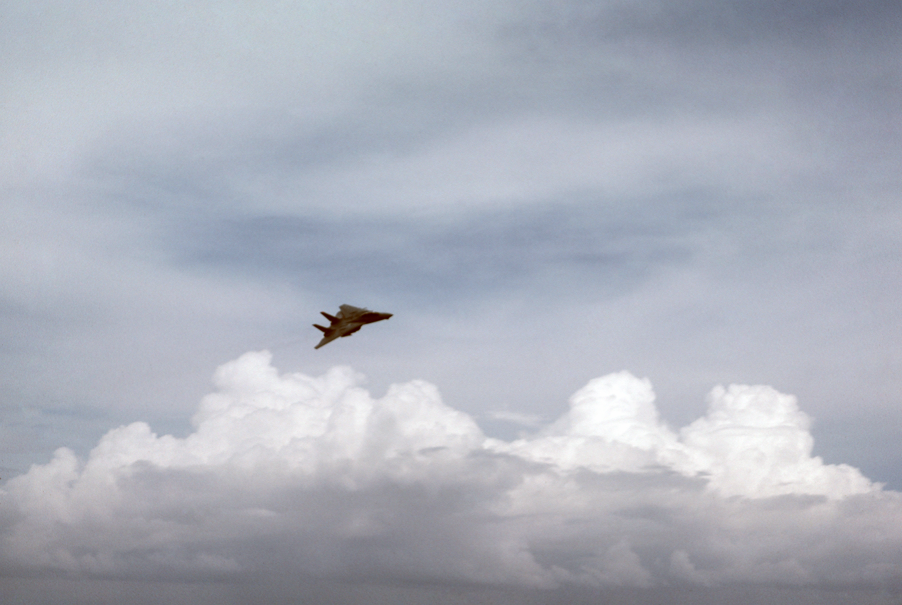 A right front view of a Carrier Air Wing 7 (CVW-7) F-14A Tomcat aircraft, painted in the Sperry camouflage scheme, as it approaches the nuclear powered aircraft carrier USS DWIGHT D - DPLA - 05c1a93d8957f889538b045a581c7 bdf