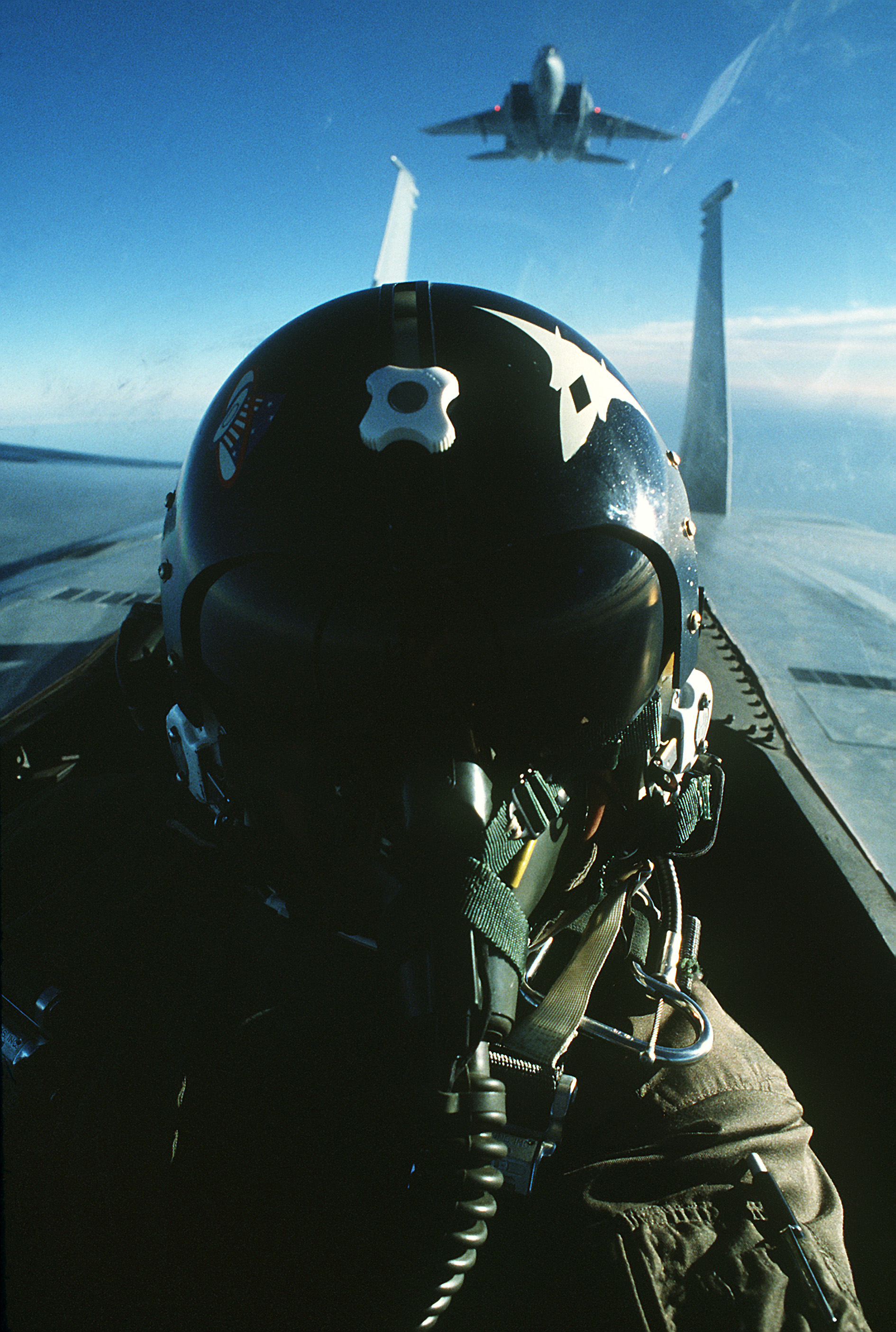 An air to air view of a pilot in the cockpit of an F-15 Eagle aircraft. Another F-15 is in the background DF ST-82-00944