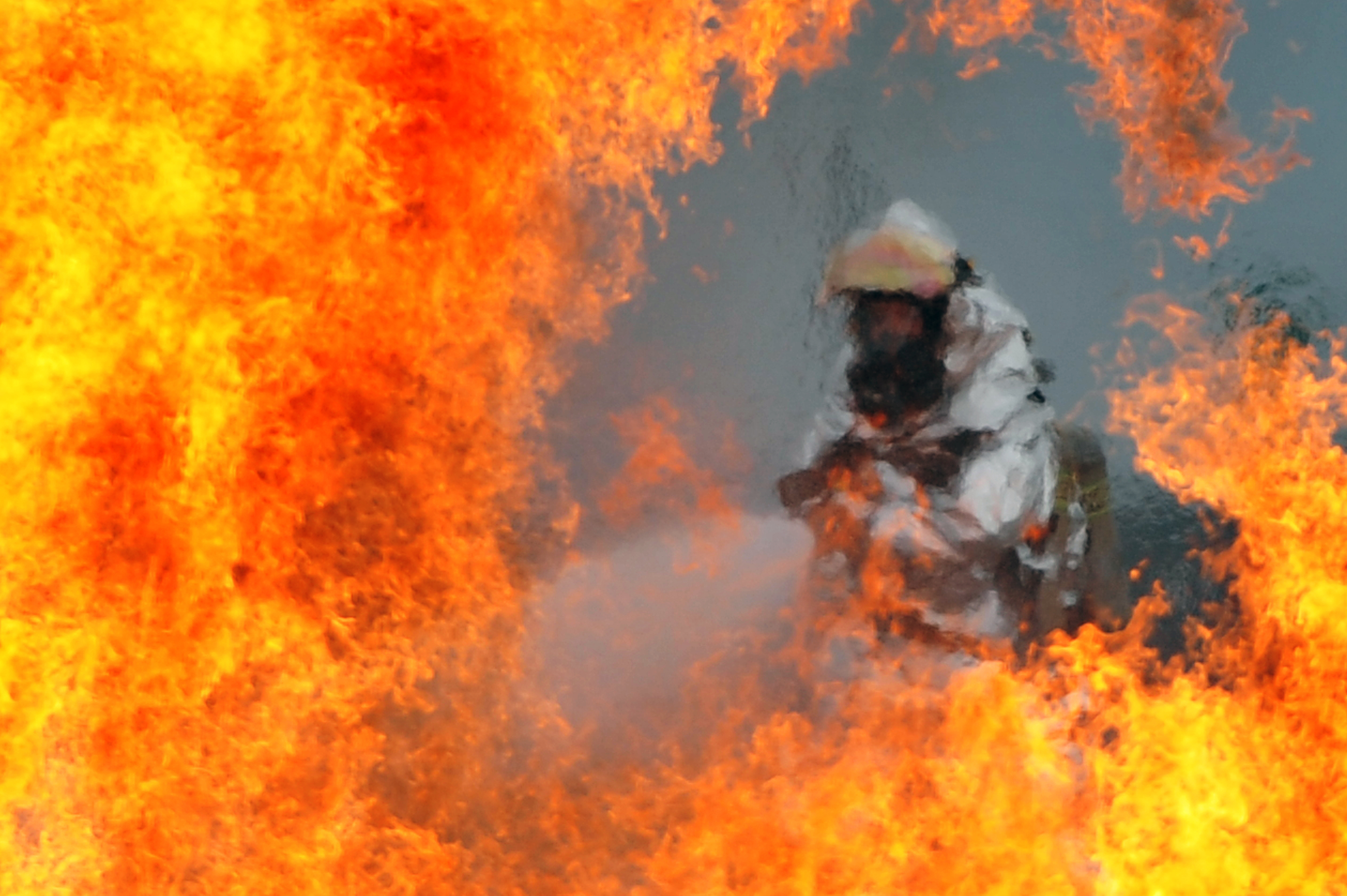 Defense gov News Photo 120723 F-HA794 089 - A U S. Air Force firefighter sprays water at the fire of a simulated C-130 Hercules plane crash during operational readiness exercise Beverly