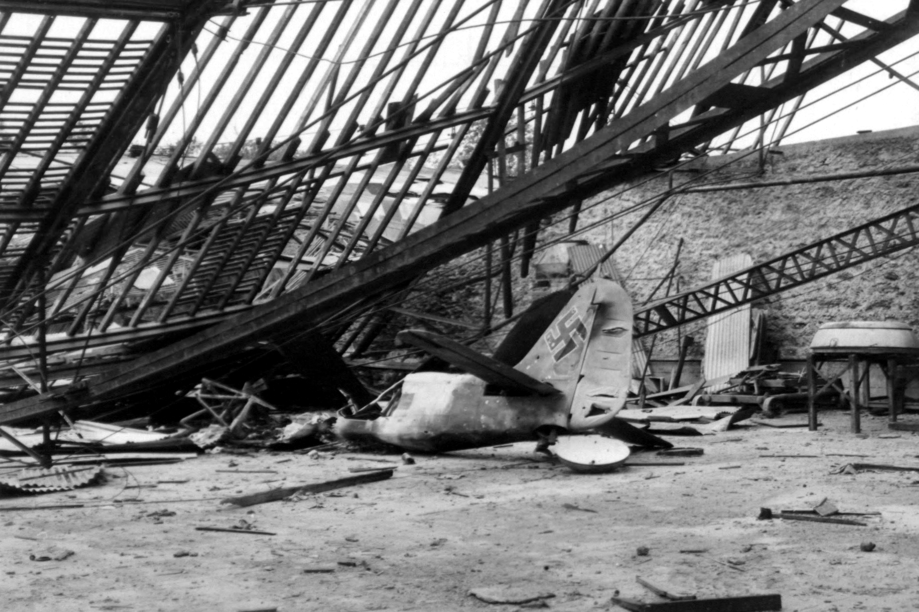 Destroyed Focke Wulf Fw 190 in a hangar at Villecoublay airfield, France, 21 September 1944 (342 FH-3A19354 A59200AC)