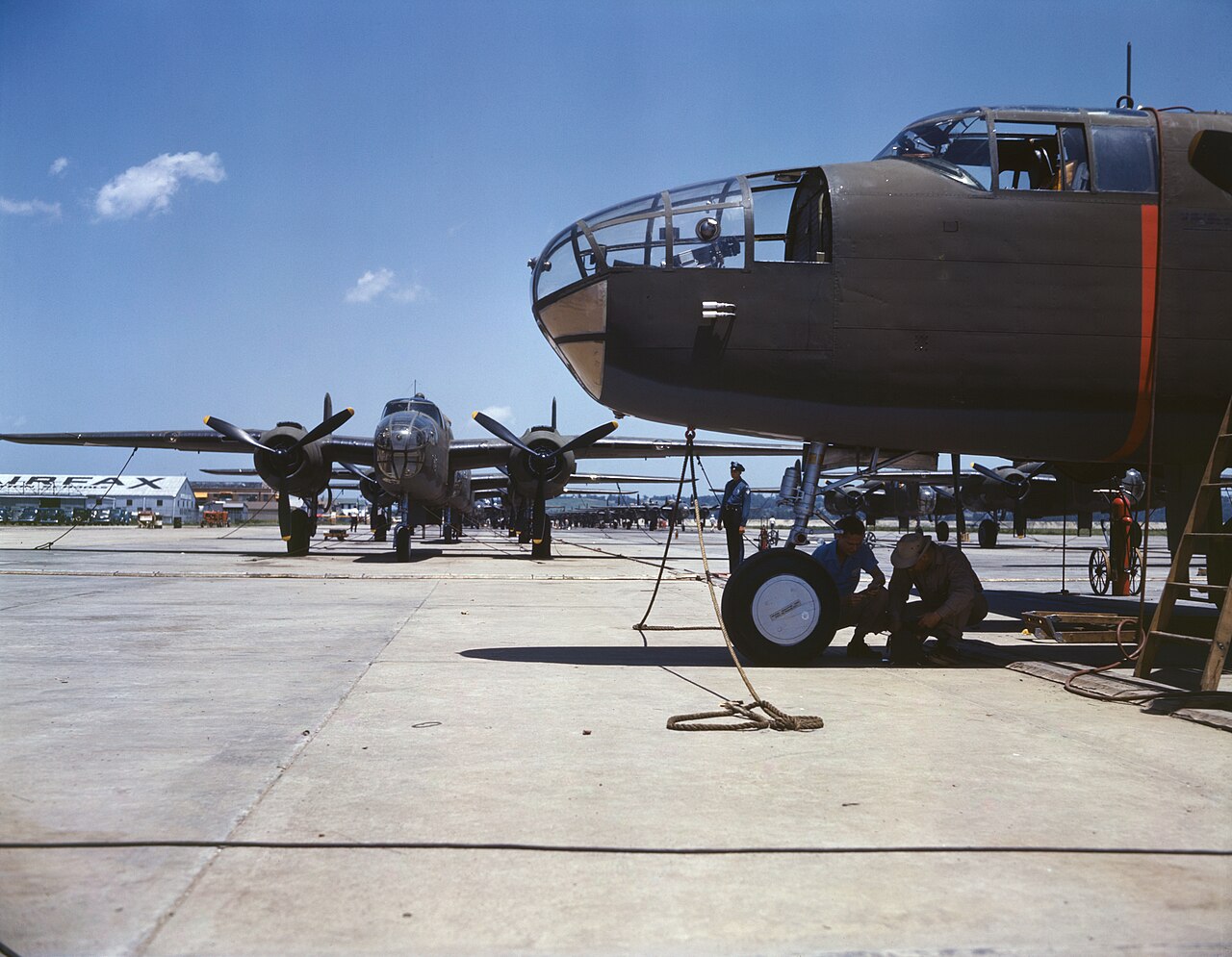New B-25 bombers lined up for final inspection and tests at the flying field of an aircraft plant, North American Aviati