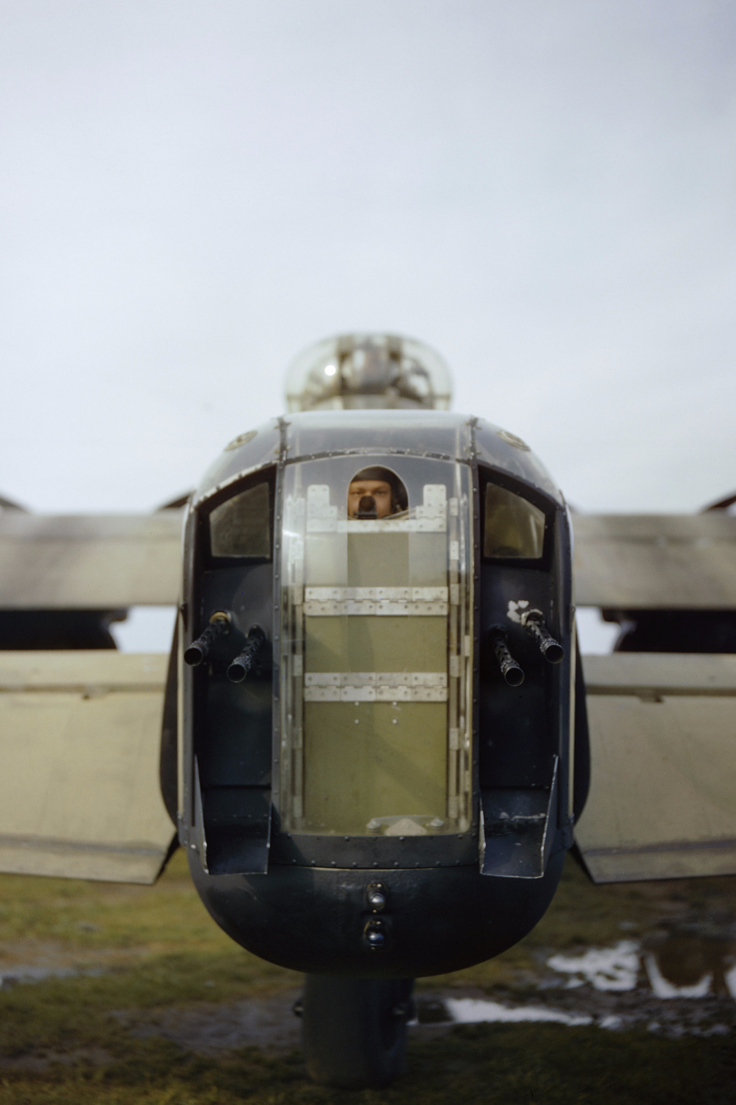 Rear gunner of a No. 44 Squadron Lancaster looking through the cut out perspex of his turret