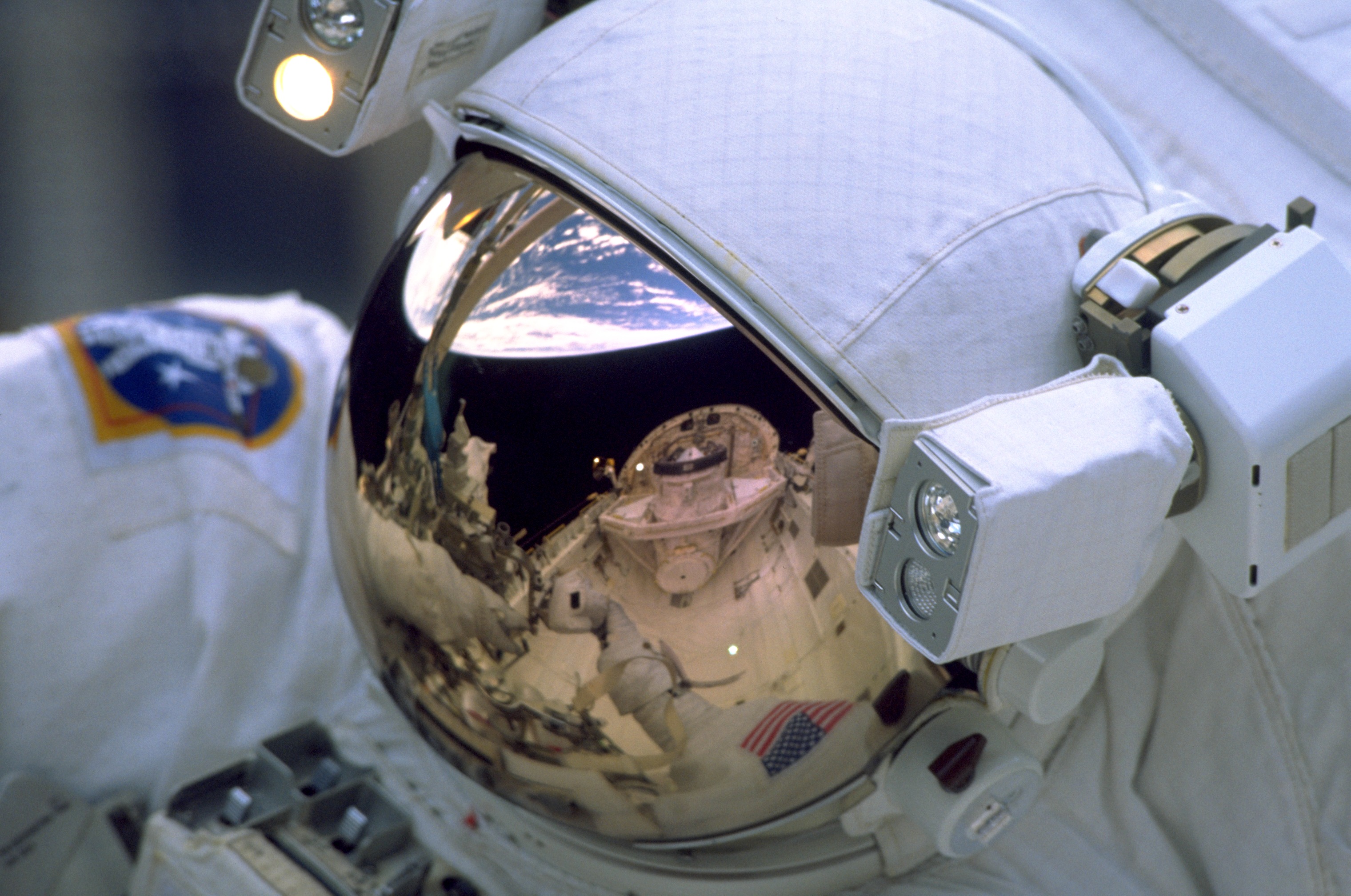 STS-103, reflejo en la visera del astronauta