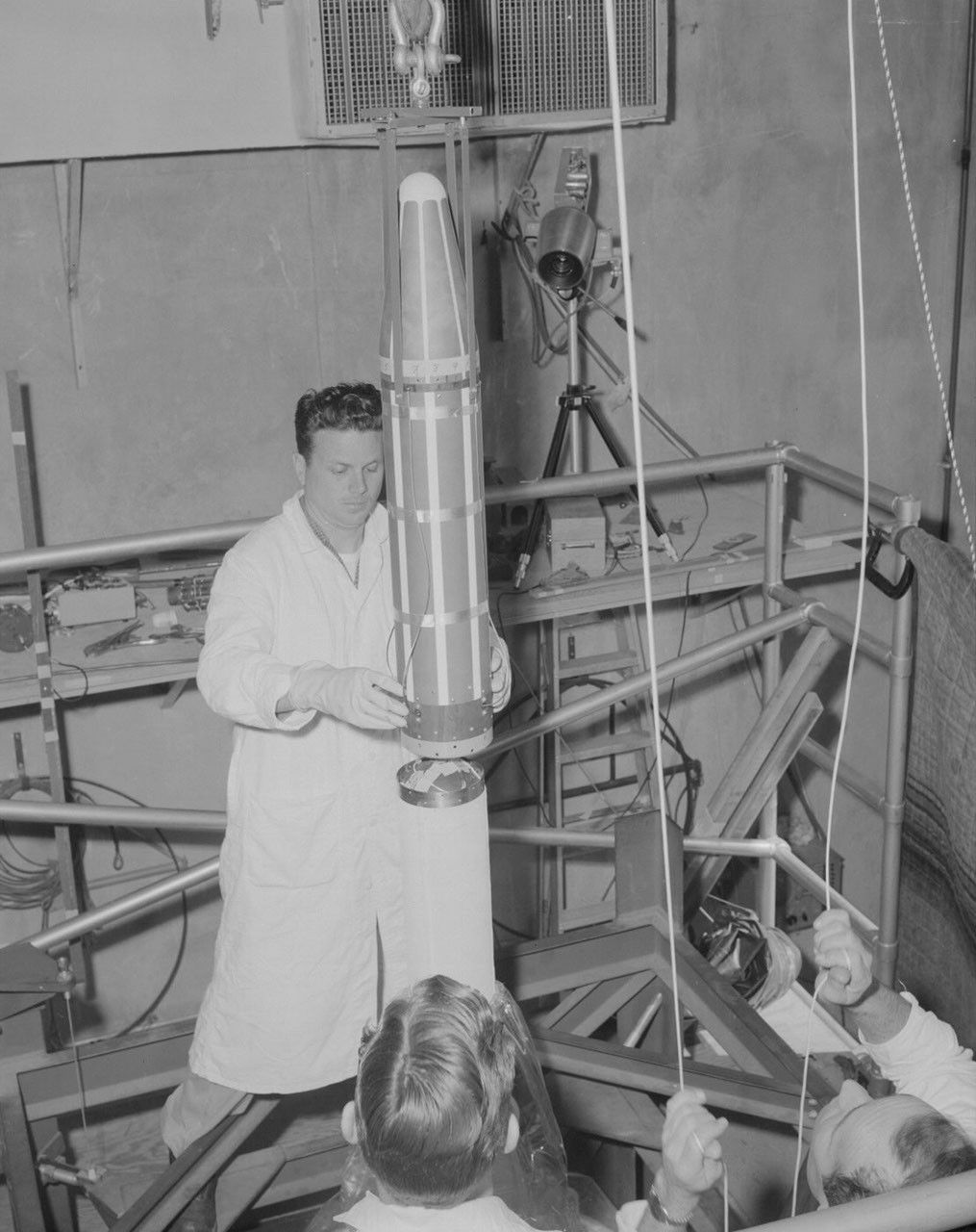 Technicians lower the Explorer 1 satellite onto the Juno I upper stage cluster