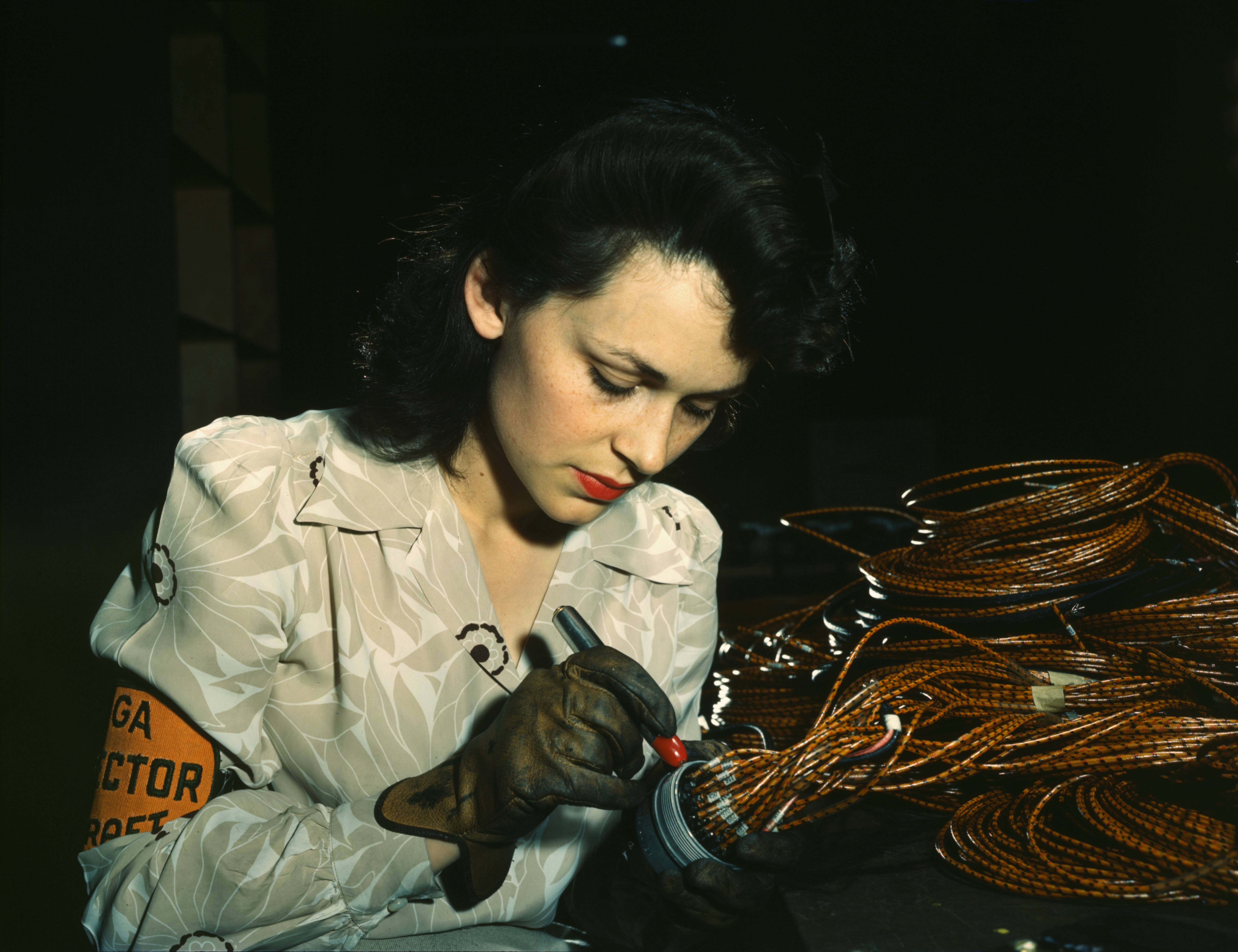 WWII Woman aircraft inspector checking electrical assemblies, Vega Aircraft Corporation, Burbank, California in June 1942