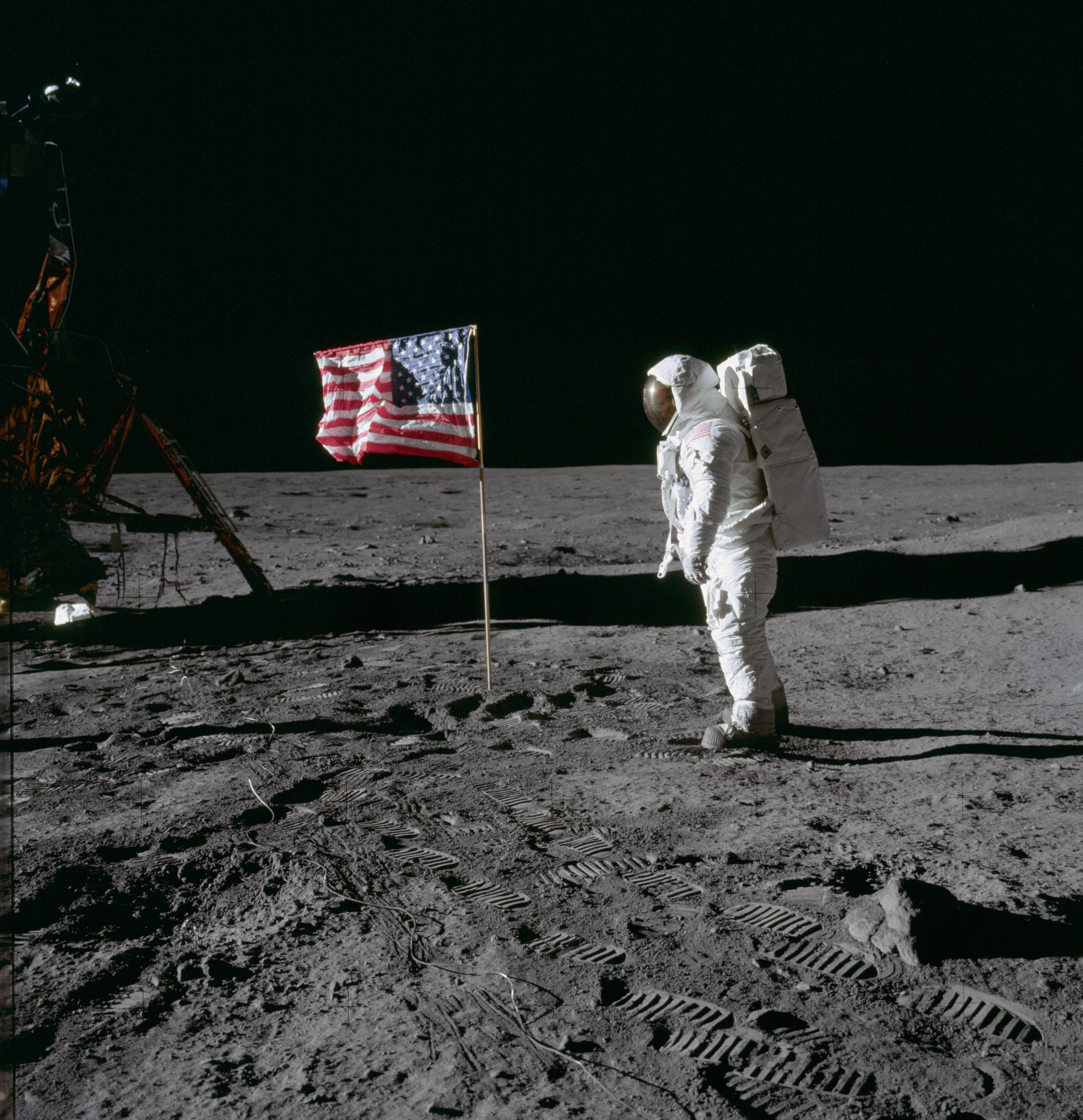 Aldrin poses for a photograph beside the deployed U S. flag