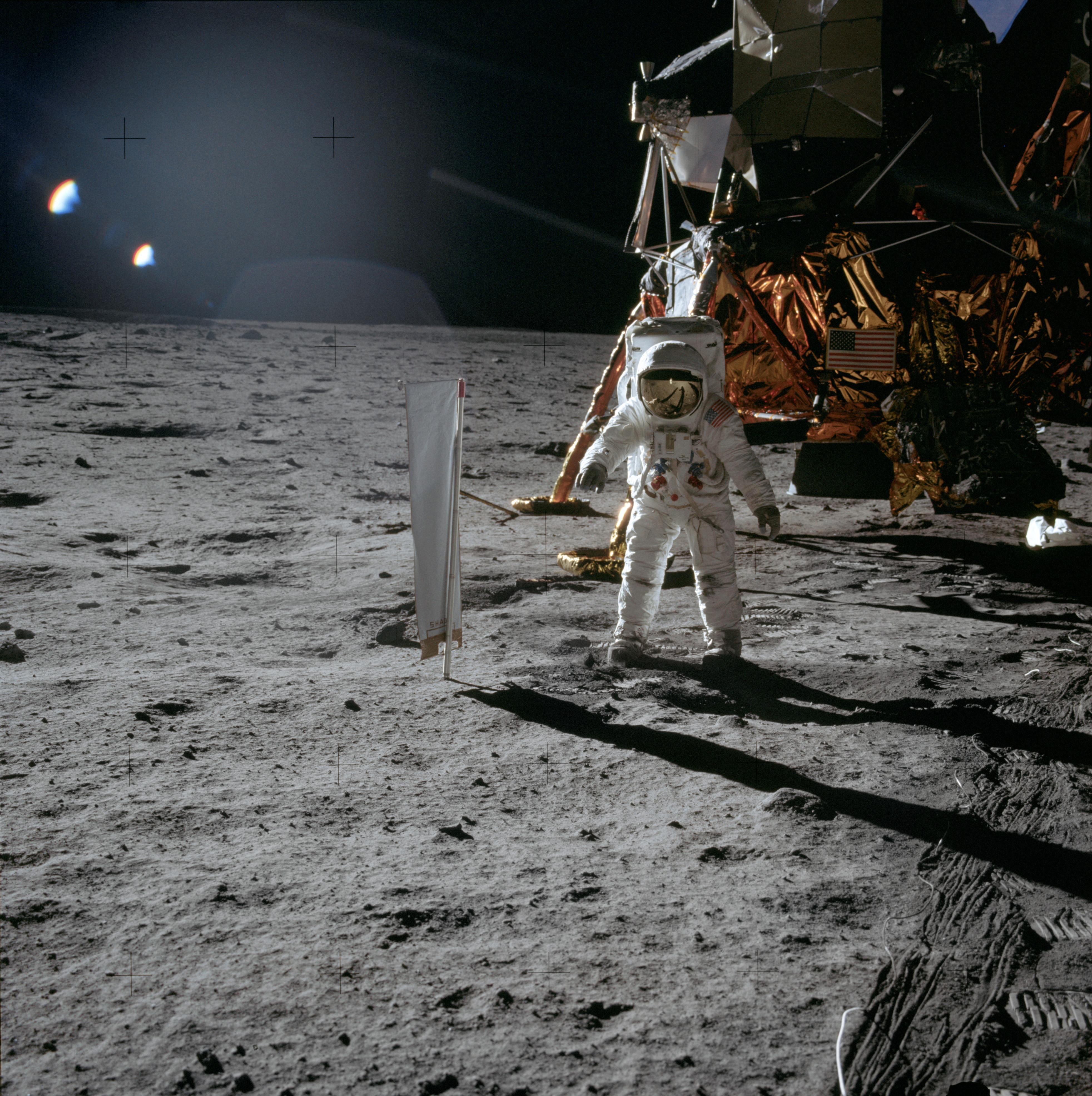 Aldrin stands beside the deployed U S. flag