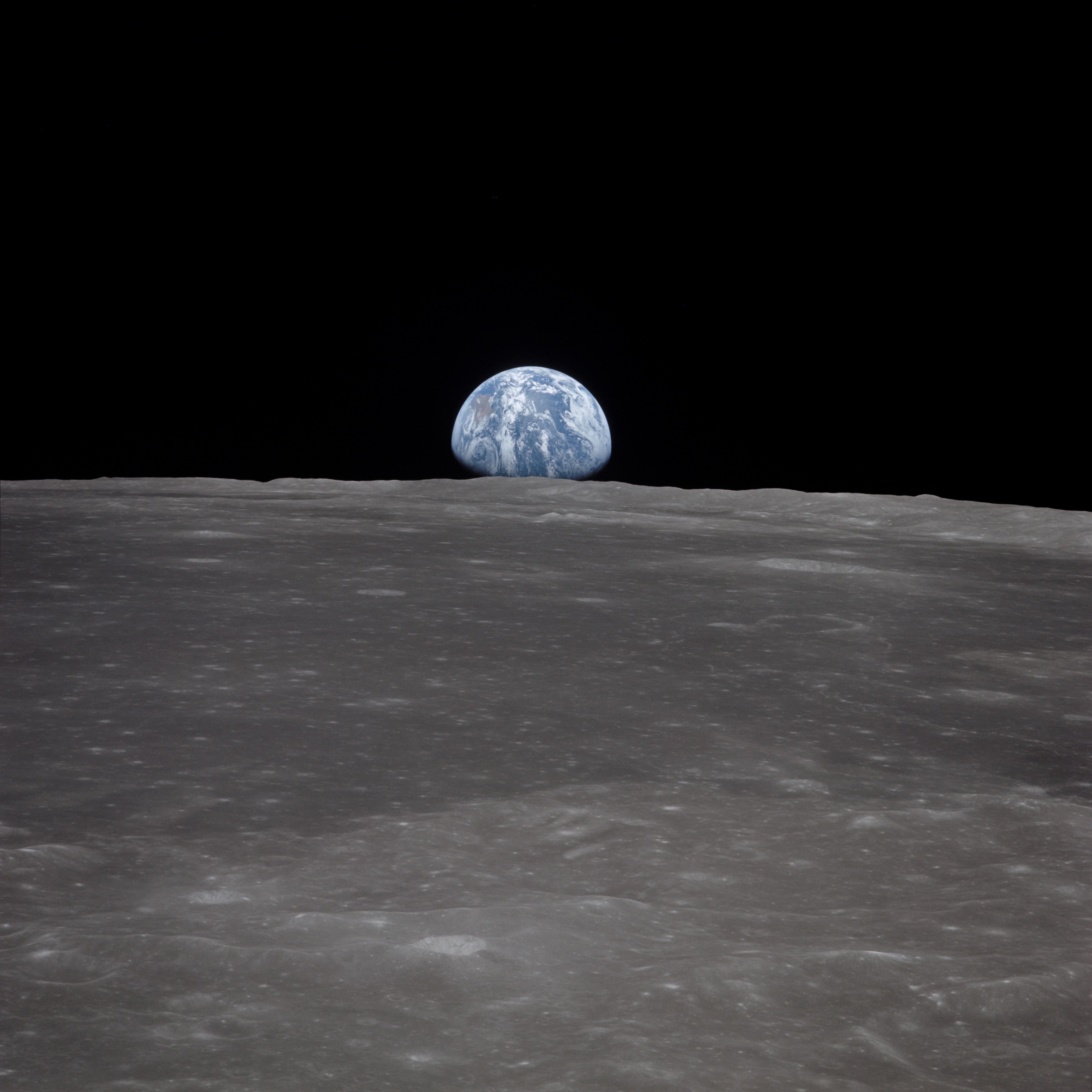 Earth rising over the Moon's horizon, seen from Apollo 11