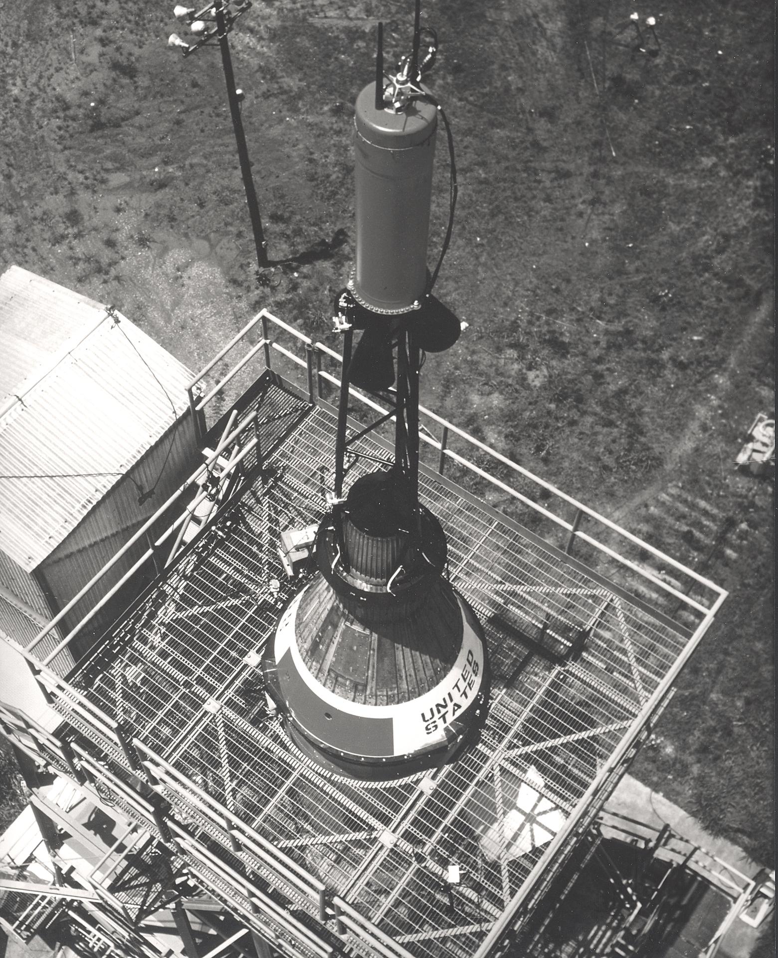 Installing the Mercury capsule and escape system on a Redstone booster before test firing