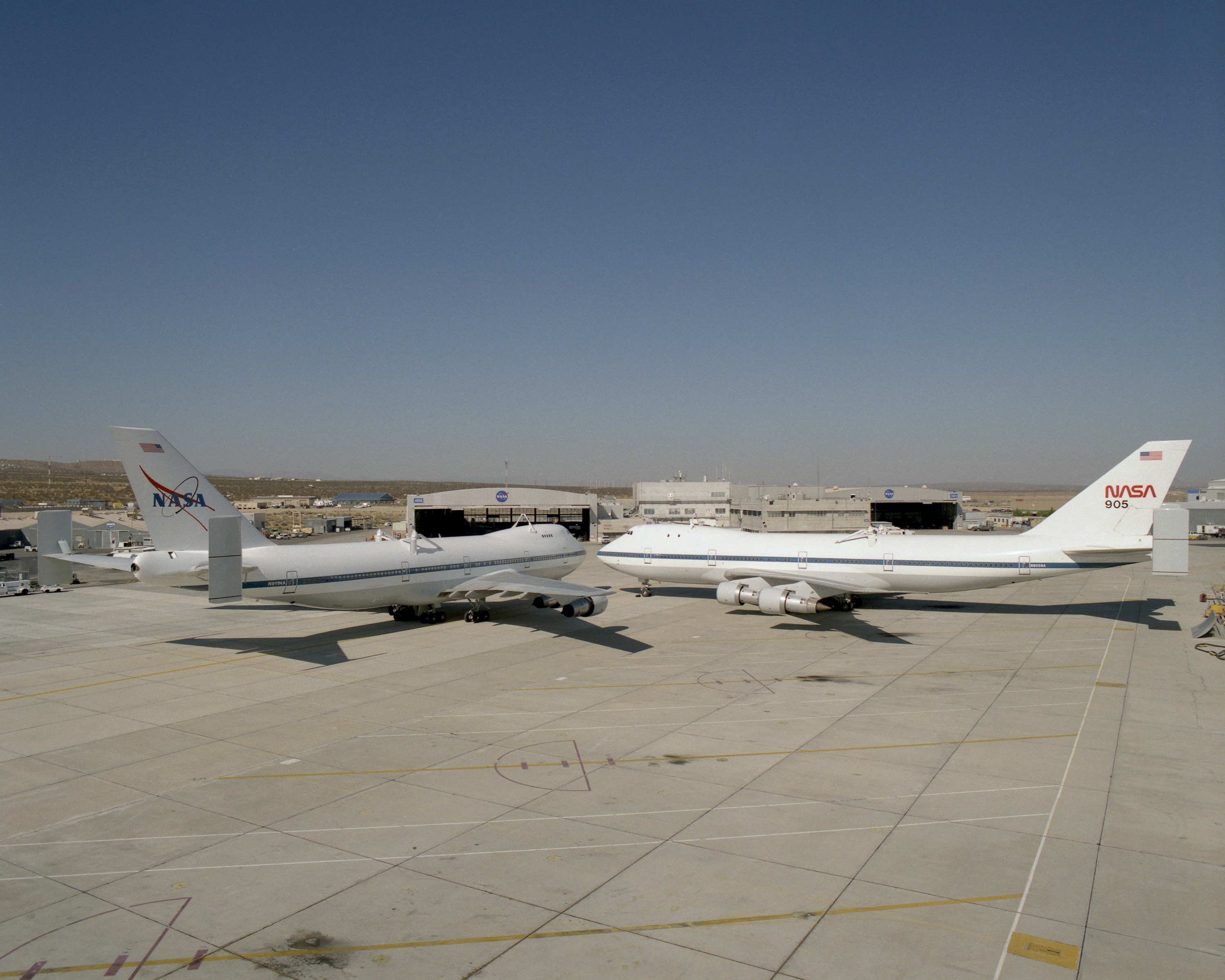 NASA's two modified Boeing 747 Shuttle Carrier Aircraft #911 (left) and #905 (right) were nose-to-nose on the ramp at NASA Dryden in this 1995 photo