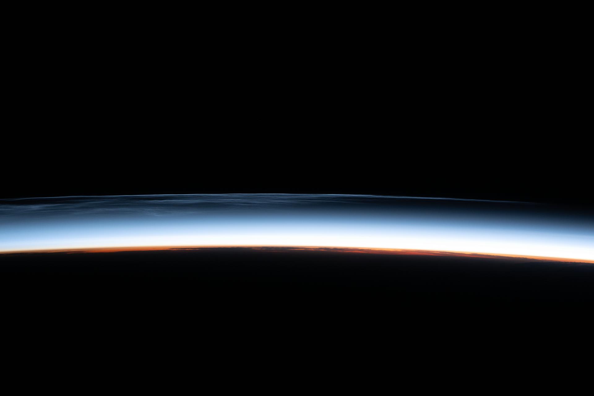 Noctilucent clouds are pictured above the North Pacific Ocean