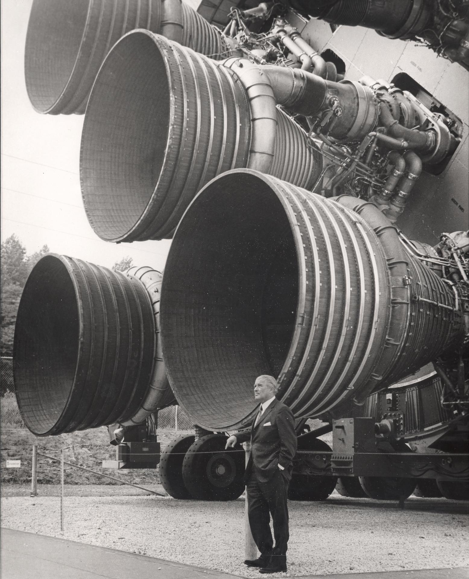 Wernher von Braun beside the five F-1 engines of a Saturn V first stage