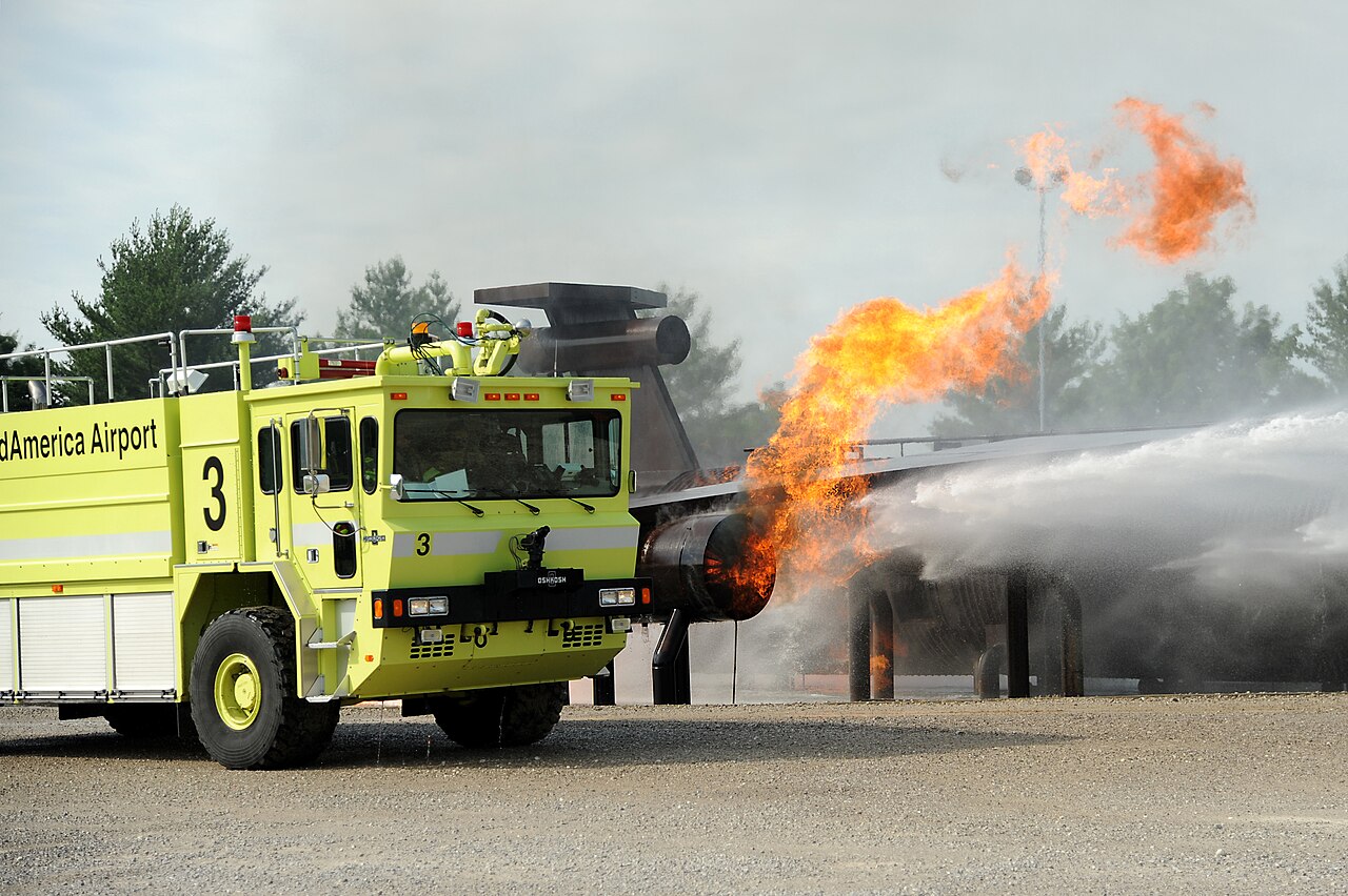 Firefighters practise with foam during a live fire training exercise.