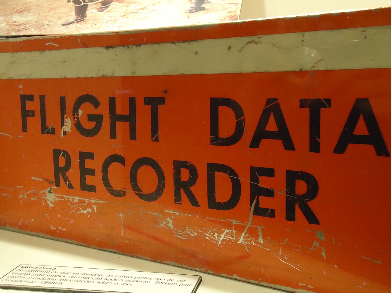 Close view of an orange-cased flight data recorder.