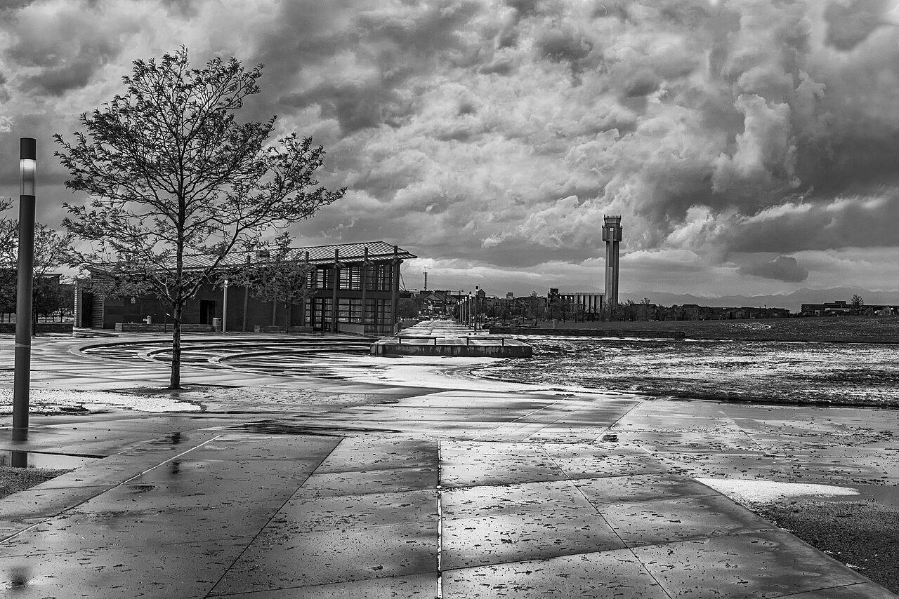 Control tower silhouetted against a stormy sky.