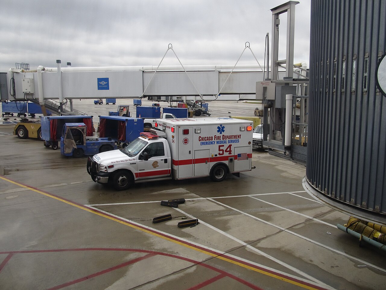 Ambulance waiting beside an airport boarding gate.