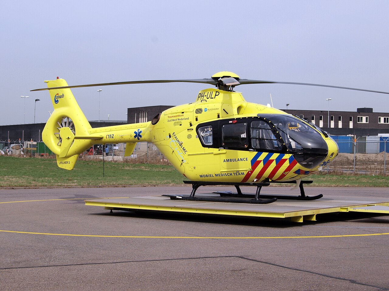 Emergency medical helicopter parked at an airport.