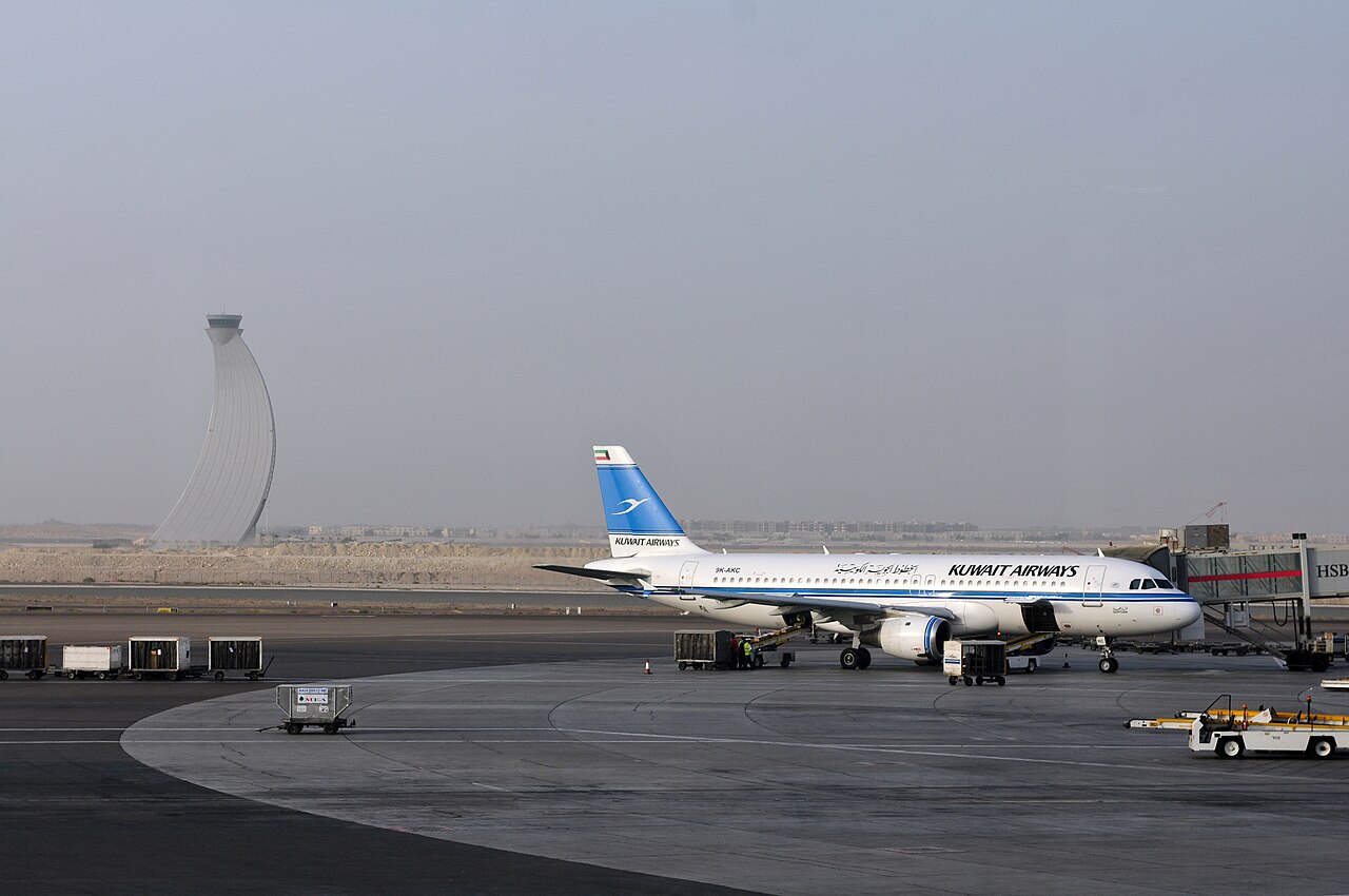 Control tower at Abu Dhabi Airport with an Airbus A320 on the apron.