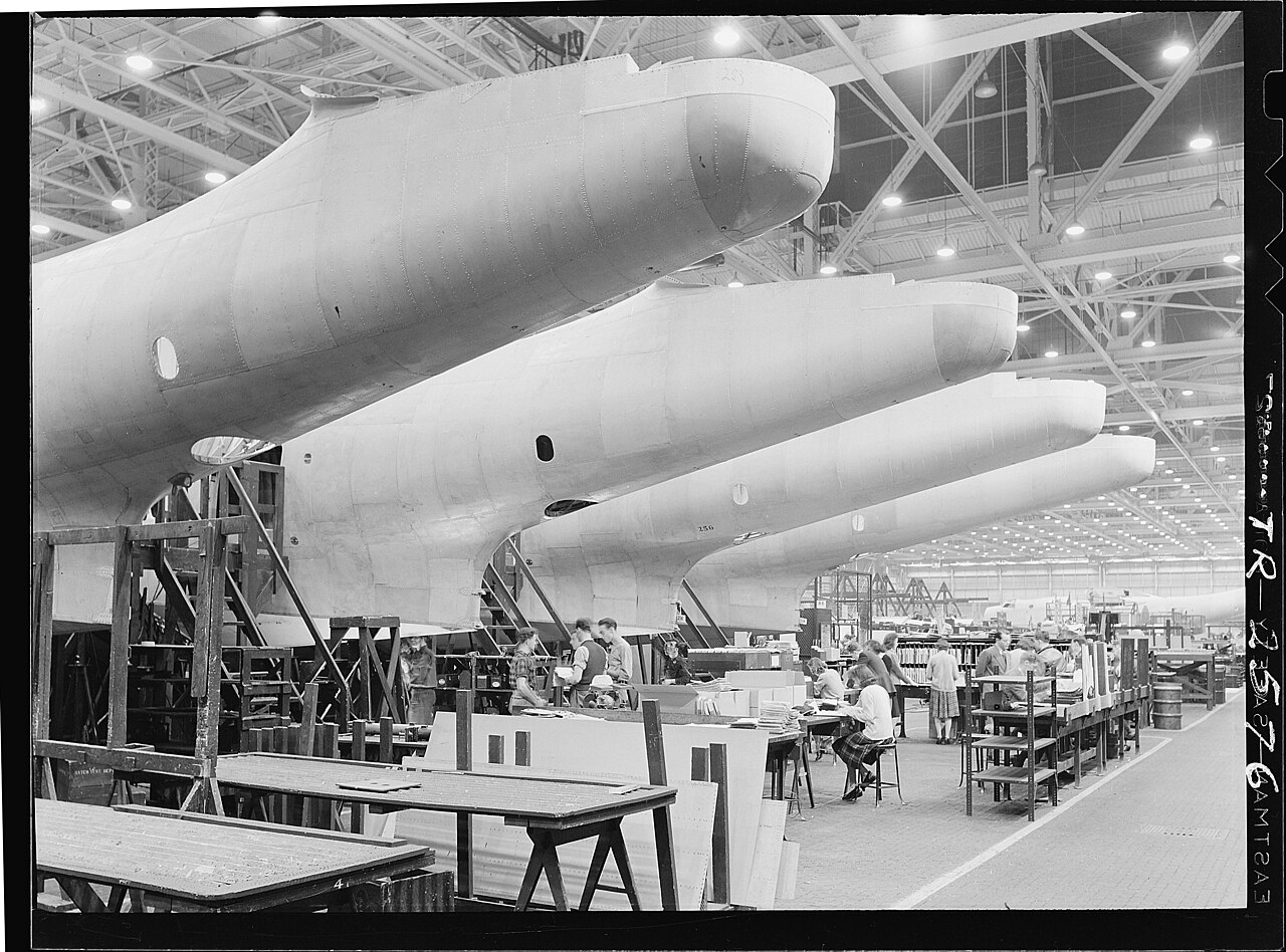Fuselages fresh out of the assembly jigs in a 1940s aircraft factory.