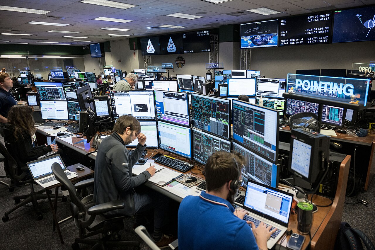 Flight controllers monitor a space mission from NASA's mission control room.