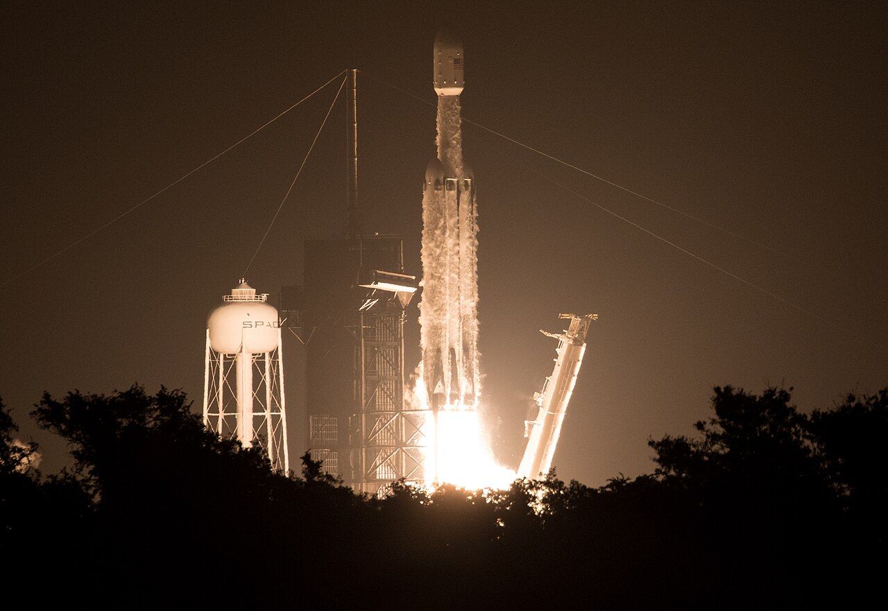 A Falcon Heavy rocket lifts off at night from Launch Complex 39A on the STP-2 mission.