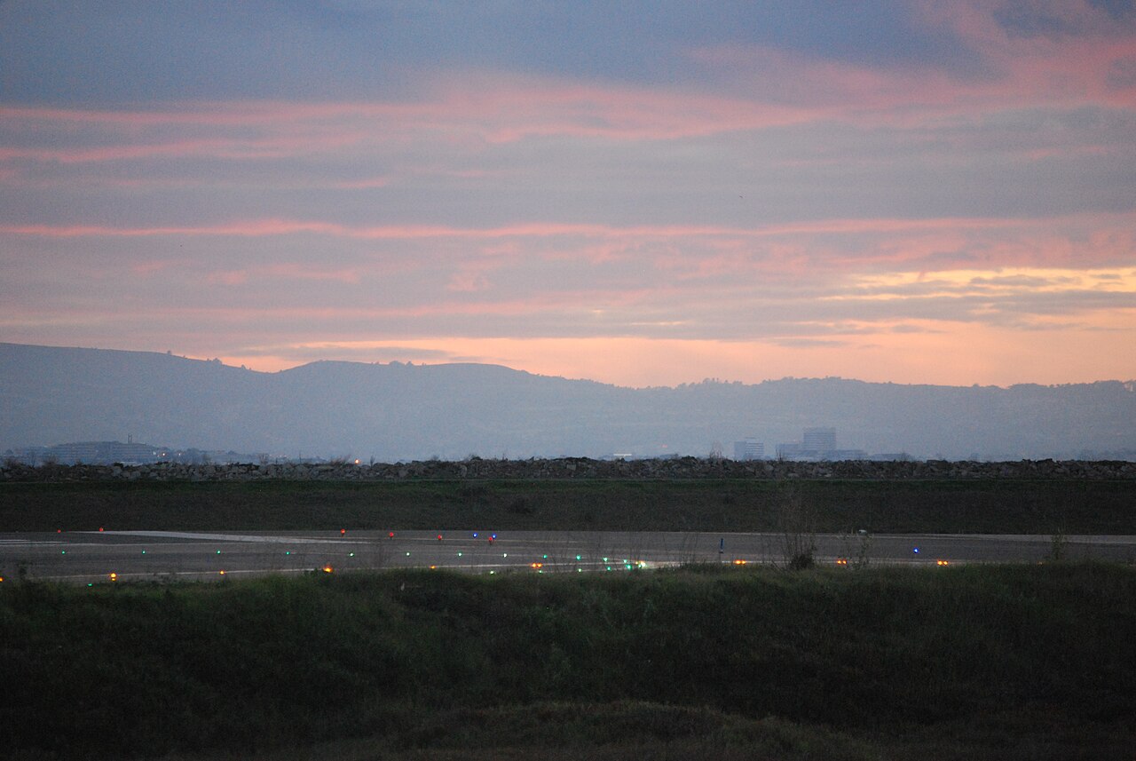 Runway lights at an airport at dusk.