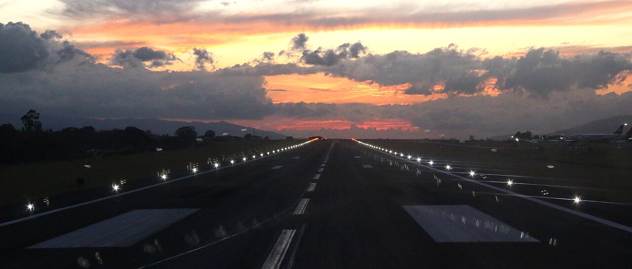 Lit runway under a sunset sky.