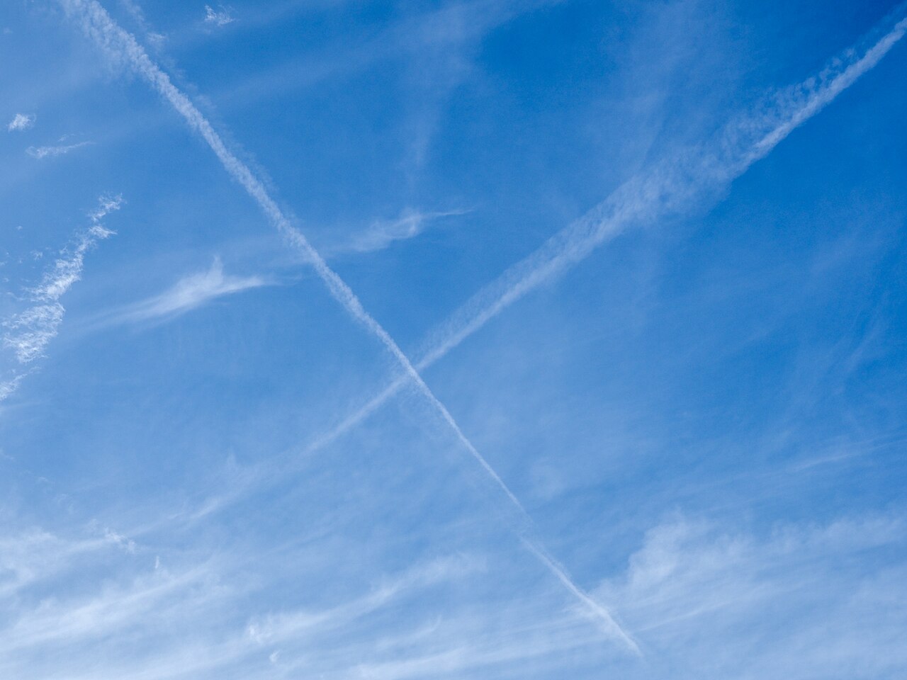 Crossed jet contrails in a blue sky.
