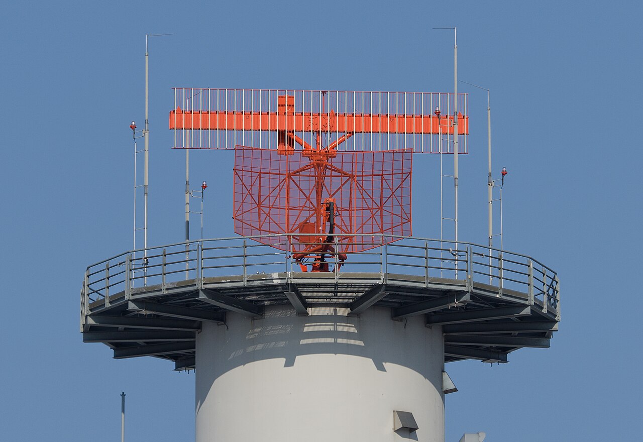 Airport radar tower against the sky.