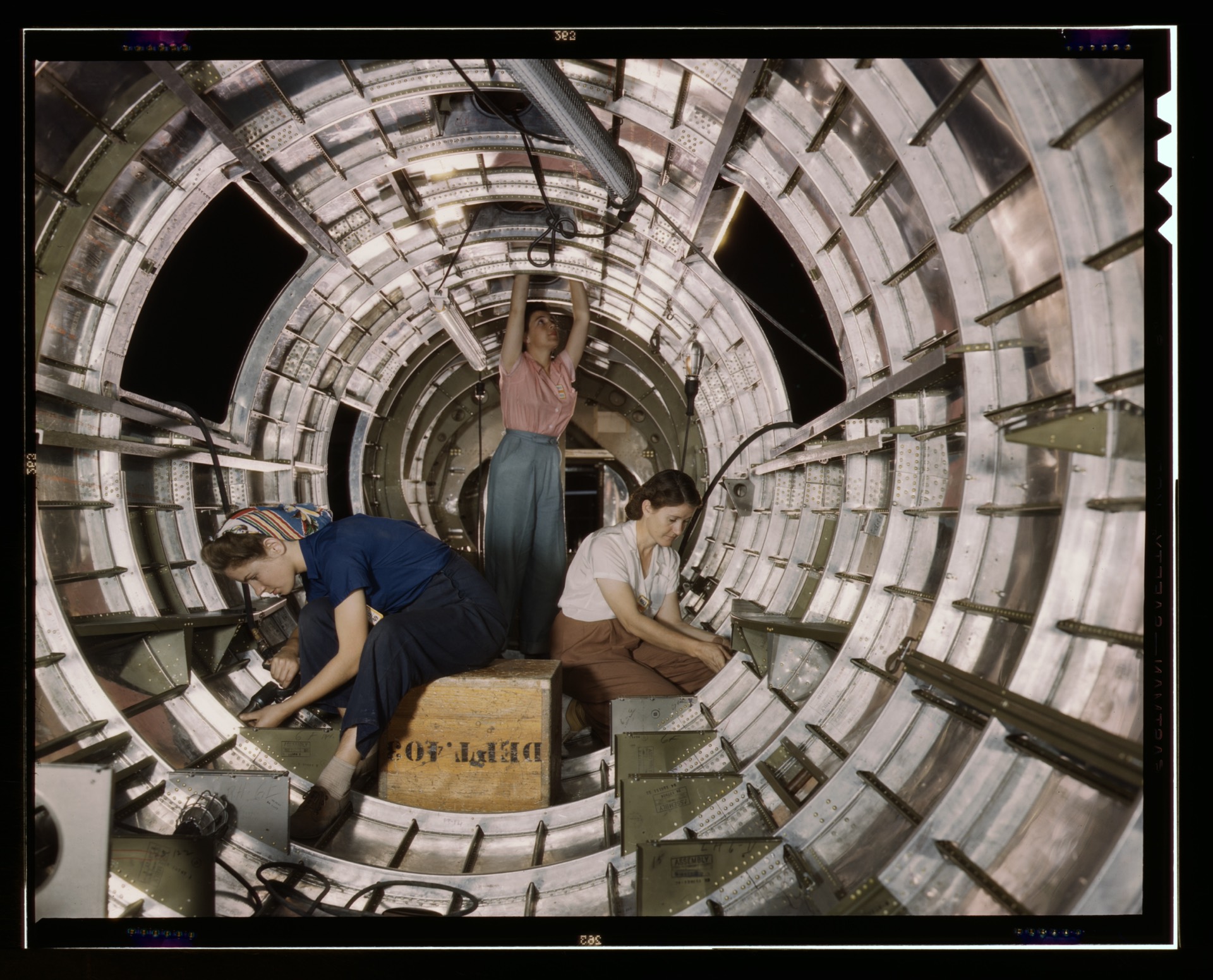Workers on an aircraft assembly line